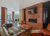 Thumbnail 11 of 31 - a living room with a couch and a television