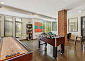 Thumbnail 10 of 31 - a game room with a foosball table and a pool table
