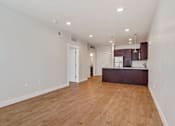 Thumbnail 21 of 31 - an empty living room and kitchen with a hard wood floor