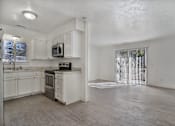 Thumbnail 4 of 14 - A kitchen with white cabinets and a microwave on the counter.