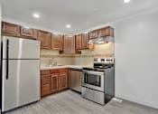Thumbnail 6 of 15 - A kitchen with a stainless steel refrigerator, oven, and microwave.