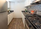 Thumbnail 14 of 32 - a kitchen with stainless steel appliances and a stove top oven
