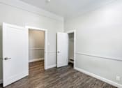 Thumbnail 13 of 19 - an empty room with white walls and a door to a closet
