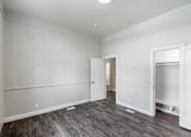 Thumbnail 15 of 19 - an empty living room with white walls and wood flooring