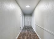 Thumbnail 17 of 19 - an empty hallway with white walls and wood floors and a closet