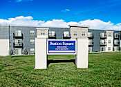 Thumbnail 2 of 20 - a sign that says station square in front of an apartment building