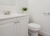 Thumbnail 17 of 17 - a white bathroom with a toilet and a sink