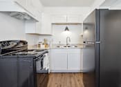 Thumbnail 9 of 17 - a kitchen with stainless steel appliances and white cabinets