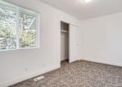 Thumbnail 13 of 17 - an empty bedroom with a large window and a closet