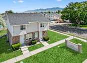 Thumbnail 1 of 17 - an aerial view of a white and brick house with a yard and grass