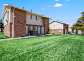Thumbnail 4 of 17 - a large lawn in front of a brick house
