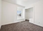Thumbnail 11 of 17 - an empty room with carpet and a closet with a window