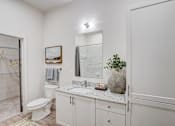 Thumbnail 9 of 19 - a bathroom with a sink and a toilet and a shower