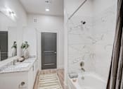 Thumbnail 18 of 19 - a white bathroom with a shower and a sink