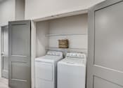Thumbnail 12 of 19 - a washer and dryer in a laundry room with a door to the closet