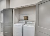 Thumbnail 15 of 23 - Inunit laundry room with washer and dryer at The Mill Old Town Apartments, Lewisville, TX