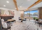 Thumbnail 7 of 23 - Resident lounge with exposed beam ceiling and balcony at The Mill Old Town Apartments, Texas, 75057