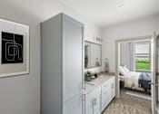 Thumbnail 14 of 16 - Bathroom vanity with granite countertop and bedroom view at The Westerly Apartments, Midlothian, 76065