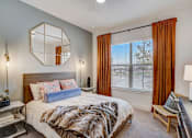 Thumbnail 7 of 19 - a bedroom with a large bed and a window with curtains