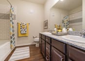 Thumbnail 6 of 16 - Modern bathroom interior at Auberge of Tyler apartments in Tyler TX featuring updated fixtures and finishes.
