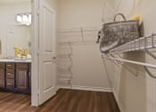 Thumbnail 7 of 16 - Walk-in closet with hanging space at Auberge of Tyler apartments in Tyler TX.
