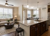 Thumbnail 11 of 24 - Spacious kitchen with a center island, bar seating, and stainless steel appliances at Auberge of Tyler.