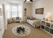 Thumbnail 18 of 24 - Bright bedroom staged as a children's room with playful décor and plenty of natural light at Auberge of Tyler.