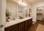 Thumbnail 22 of 24 - Modern bathroom with a spacious vanity, large mirror, and updated fixtures in a two-bedroom apartment at Auberge of Tyler.