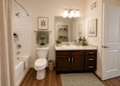 Thumbnail 16 of 24 - Secondary bathroom with vanity, bathtub, and modern finishes in a two-bedroom apartment at Auberge of Tyler.