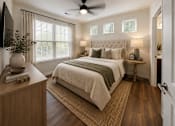 Thumbnail 23 of 24 - Primary bedroom with large windows, ceiling fan, and modern finishes in a two-bedroom apartment at Auberge of Tyler.