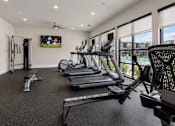 Thumbnail 6 of 24 - Modern fitness center with cardio equipment, strength machines, and free weights at Auberge of Tyler.