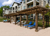 Thumbnail 4 of 24 - Shaded poolside pergola with lounge seating beside the swimming pool at Auberge of Tyler.