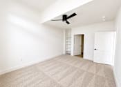Thumbnail 45 of 47 - Large  bedroom with plush carpeting, ceiling fan and abundant natural light.