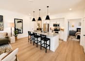 Thumbnail 9 of 47 - Bright open-concept apartment with modern kitchen, large island and spacious living area.