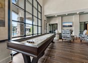 Thumbnail 11 of 16 - A pool table is in the middle of a room with a view of the backyard.