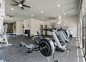 Thumbnail 15 of 16 - A gym with treadmills and elliptical machines.