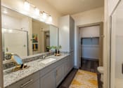Thumbnail 25 of 35 - a bathroom with gray cabinets and a yellow rug at One Preston Station, Celina, TX
