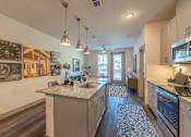 Thumbnail 11 of 35 - a kitchen with granite countertops and stainless steel appliances at One Preston Station, Texas, 75009