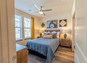 Thumbnail 29 of 35 - a bedroom with a bed and a ceiling fan at One Preston Station, Celina, TX, 75009