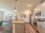 Thumbnail 19 of 35 - a spacious kitchen with stainless steel appliances and granite countertops at One Preston Station, Celina, TX, 75009