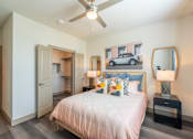 Thumbnail 26 of 35 - a bedroom with a bed and a ceiling fan at One Preston Station, Celina, Texas