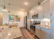 Thumbnail 18 of 35 - a kitchen with granite countertops and stainless steel appliances at One Preston Station, Texas, 75009