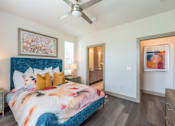 Thumbnail 24 of 35 - a bedroom with a bed and a ceiling fan at One Preston Station, Celina, TX, 75009