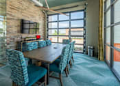 Thumbnail 13 of 35 - a conference room with a wooden table and blue chairs at One Preston Station, Celina, 75009