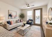 Thumbnail 27 of 32 - Modern apartment living room with comfortable seating, large windows, and contemporary finishes at One Preston Station Apartments in Celina, Texas.