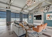Thumbnail 10 of 32 - Stylish resident clubroom with lounge seating at One Preston Station Apartments.
