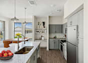 Thumbnail 15 of 16 - Modern kitchen with island and stainless appliances at The Westerly Apartments, Midlothian