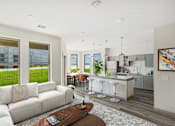 Thumbnail 11 of 16 - Open concept living room and kitchen with island seating at The Westerly Apartments, Texas
