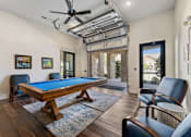 Thumbnail 5 of 19 - Clubhouse game room with pool table at Auberge of Burleson apartments in Burleson TX.
