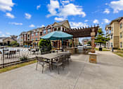 Thumbnail 17 of 19 - Poolside patio seating area at Auberge of Burleson apartments in Burleson TX.